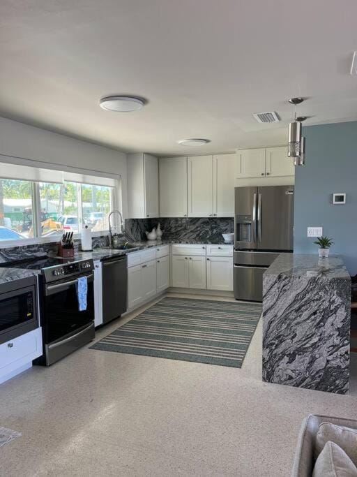 Kitchen or kitchenette, dishwasher, oven, stove, toaster