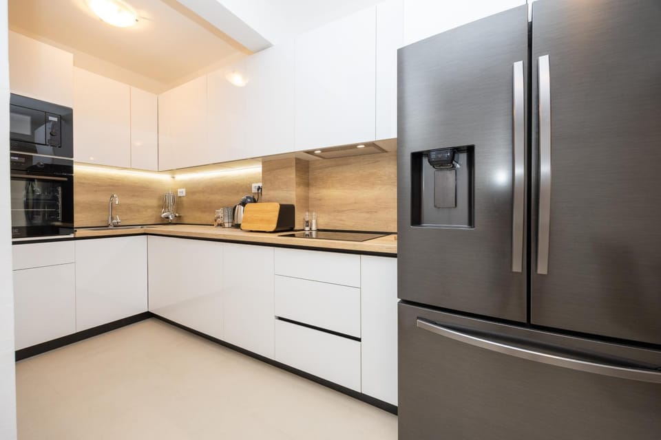 Kitchen or kitchenette, dishwasher, oven, stove