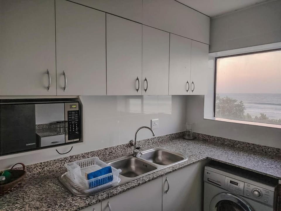 Kitchen or kitchenette, oven, stove, washing machine