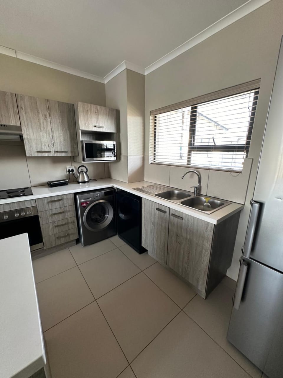 Kitchen or kitchenette, dishwasher, stove, toaster, washing machine
