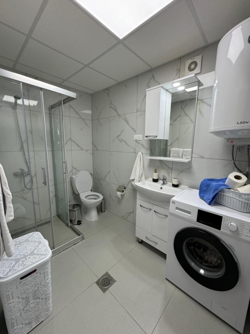Shower, Toilet, Bathroom, flat iron, hair dryier, towels, washing machine, dryer