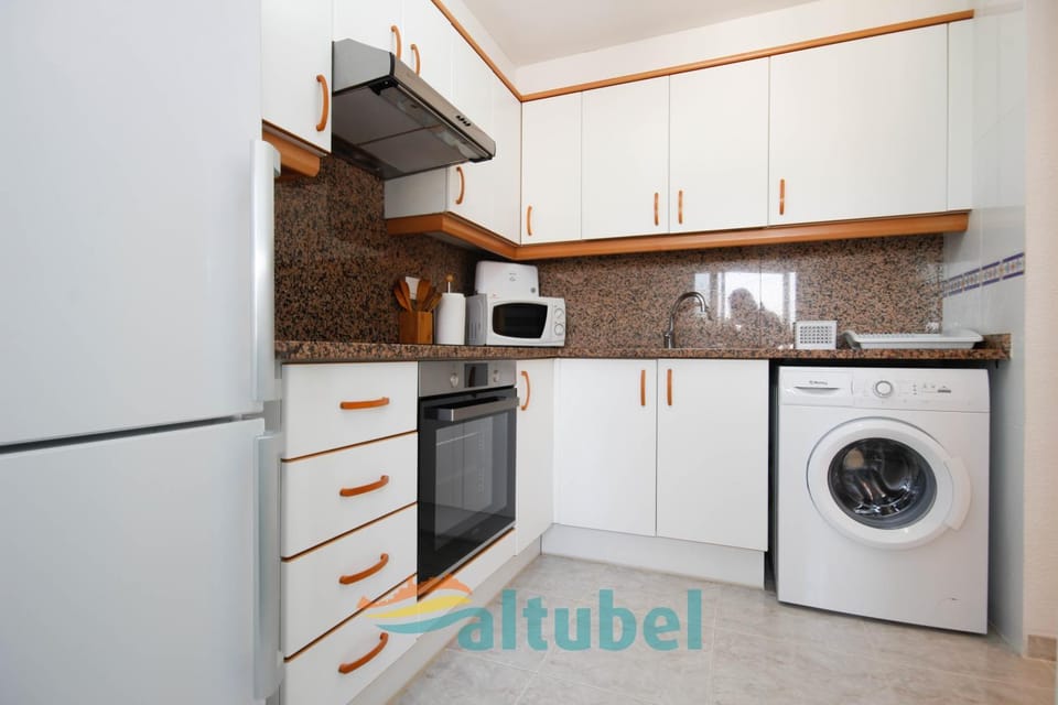 Kitchen or kitchenette, oven, stove, washing machine