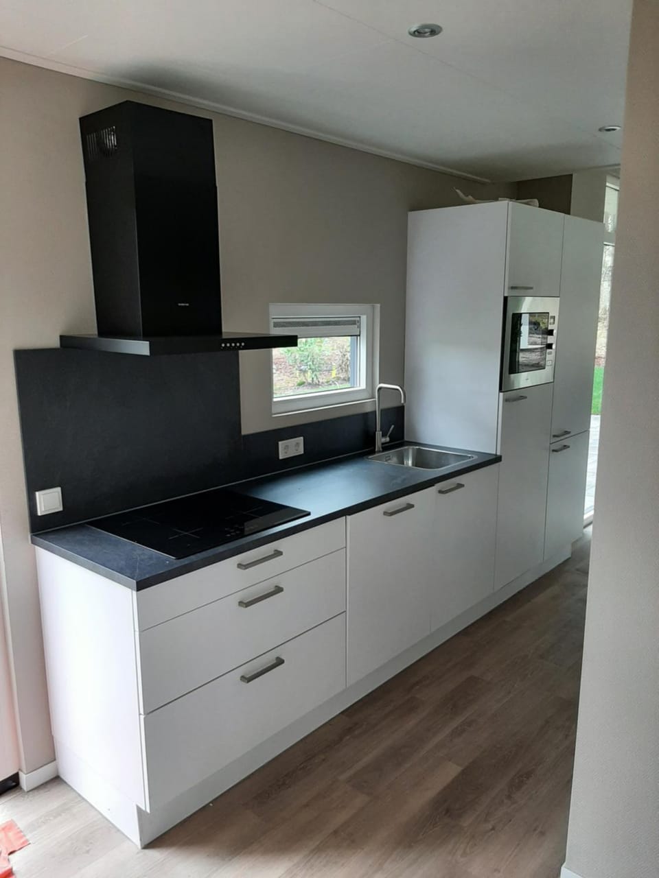 Kitchen or kitchenette, dishwasher, oven, stove