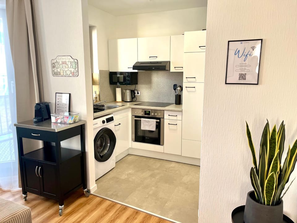 Kitchen or kitchenette, oven, stove, toaster, washing machine