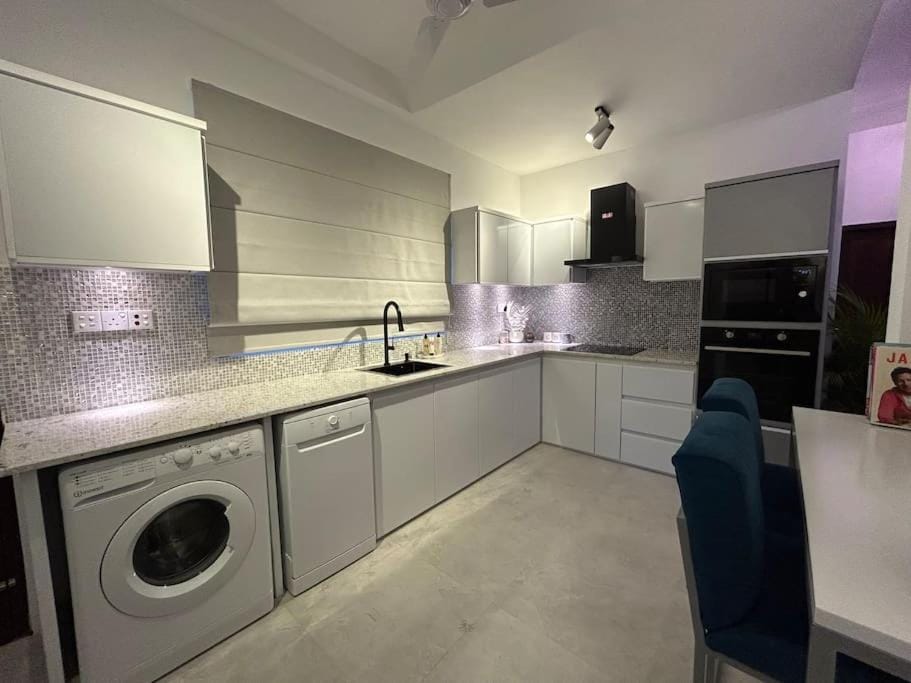 Kitchen or kitchenette, dishwasher, oven, stove, washing machine