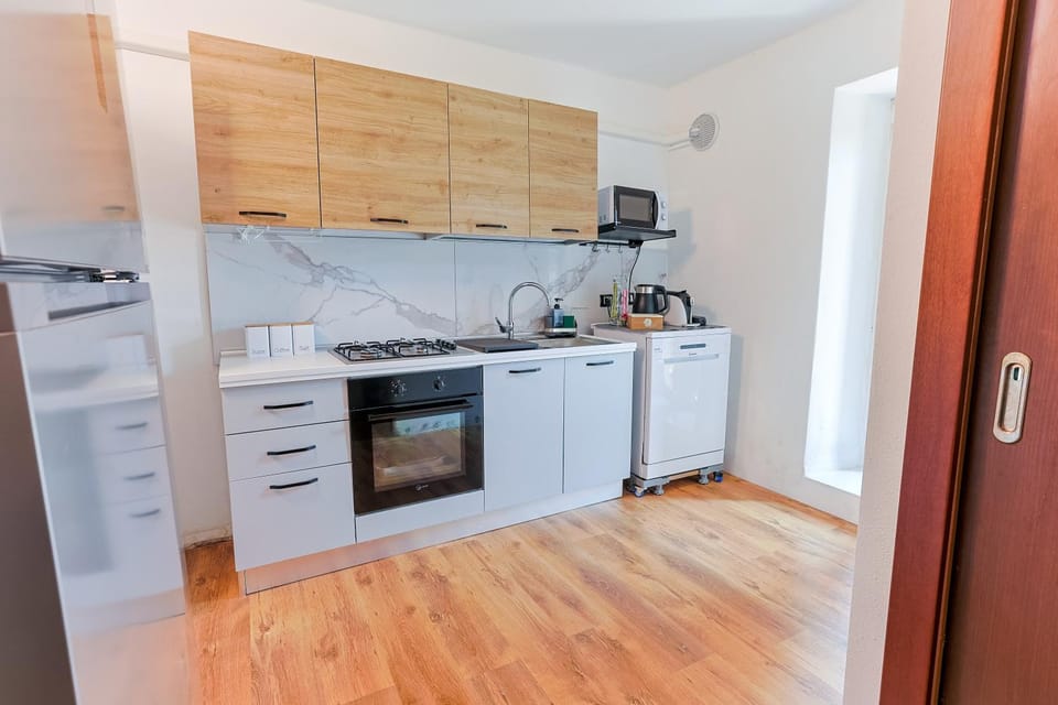 Kitchen or kitchenette, dishwasher, microwave, oven, stove, toaster