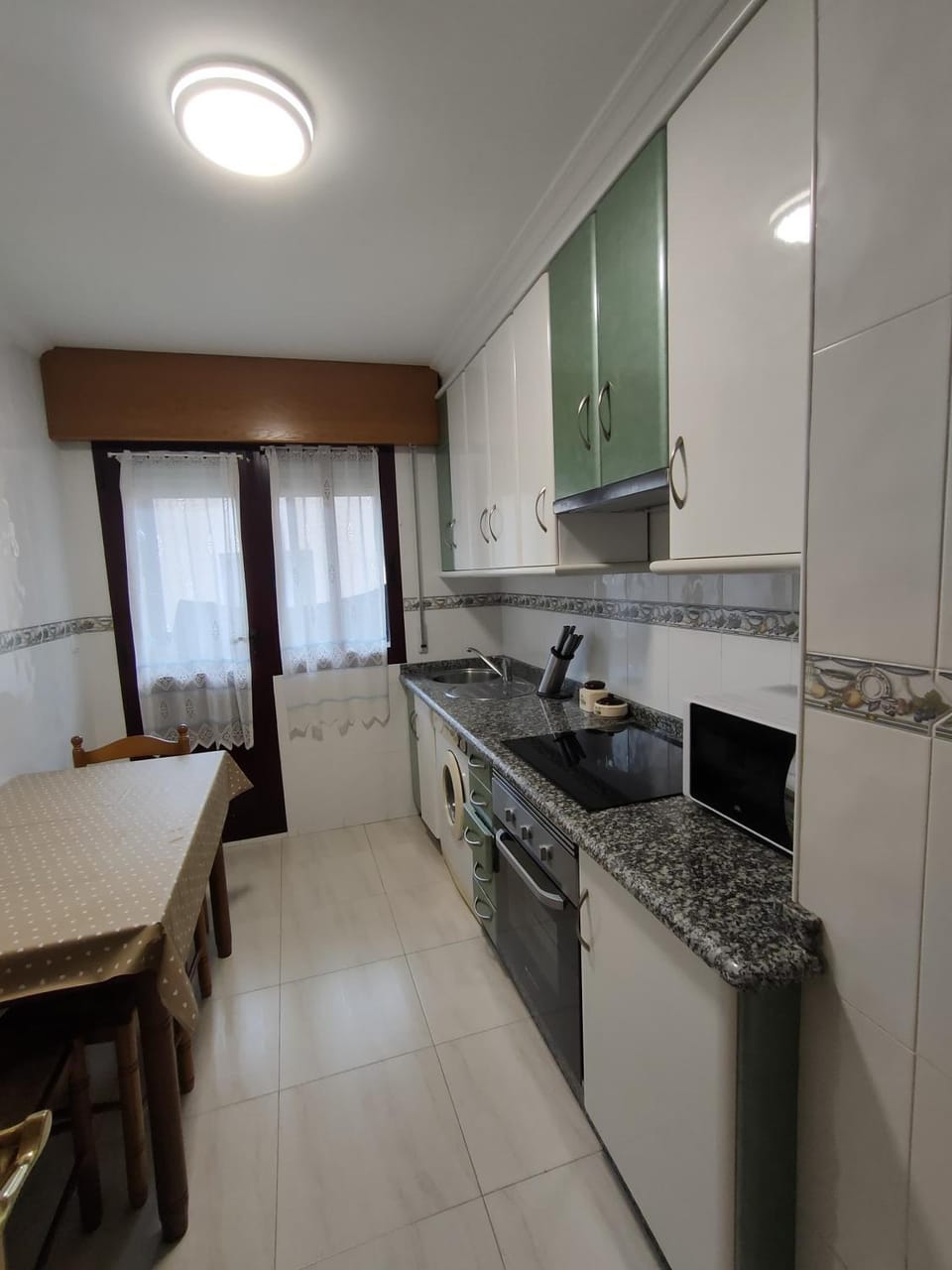 Kitchen or kitchenette, microwave, oven, stove