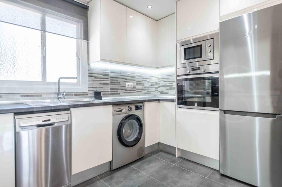 Kitchen or kitchenette, dishwasher, oven, stove, toaster, washing machine
