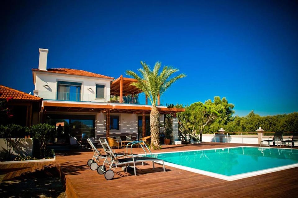 Property building, Patio, Pool view, Swimming pool, sunbed