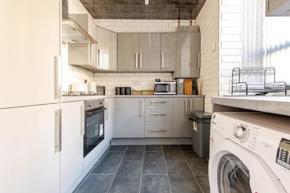 Kitchen or kitchenette, microwave, oven, stove, toaster, washing machine