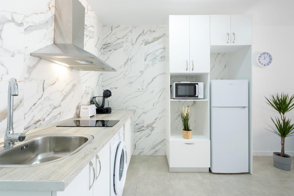 Kitchen or kitchenette, microwave, stove, washing machine