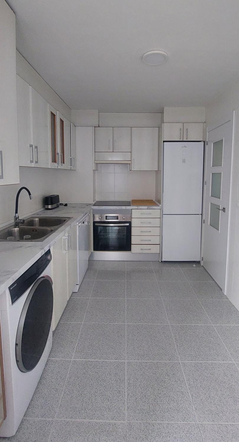 Kitchen or kitchenette, dishwasher, oven, stove, toaster, washing machine