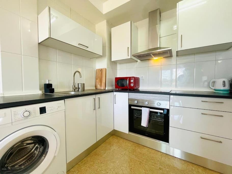 Kitchen or kitchenette, oven, stove, washing machine