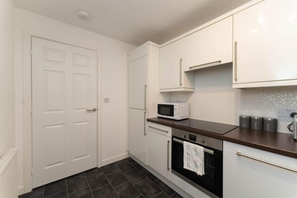 Kitchen or kitchenette, dishwasher, oven, stove