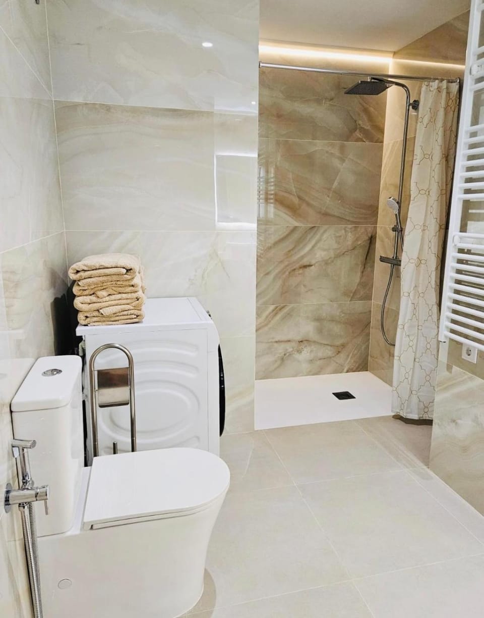 Shower, Toilet, Bathroom, hair dryier, towels, washing machine, dryer