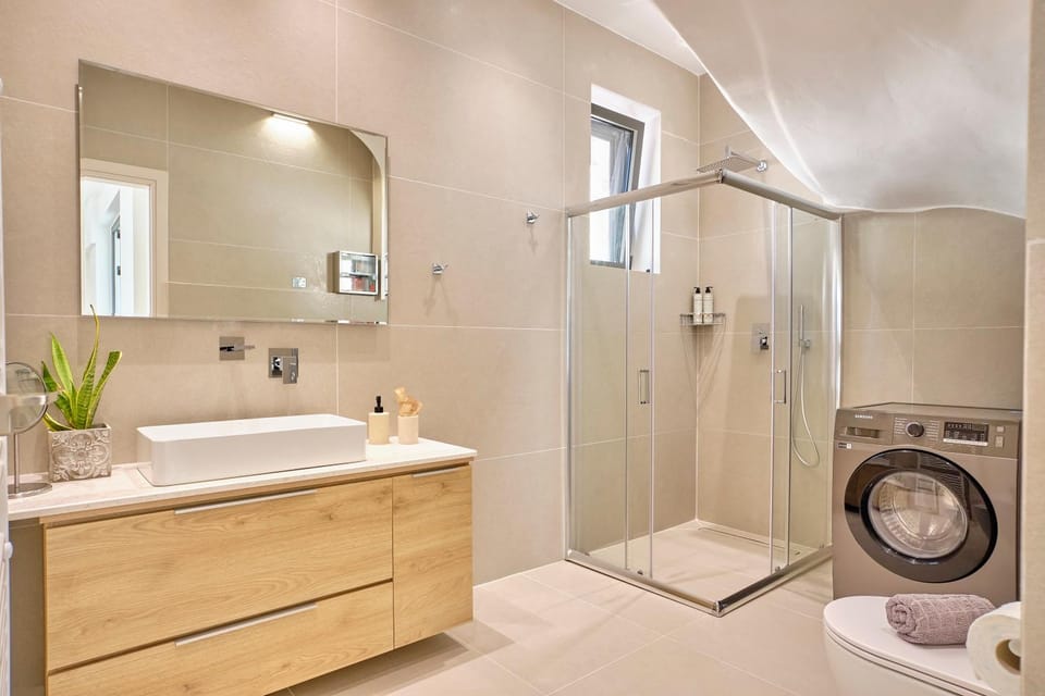 Shower, Toilet, towels, washing machine, dryer