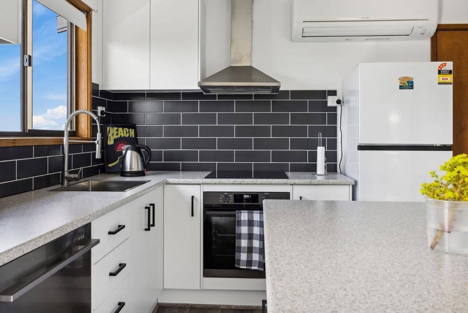 Kitchen or kitchenette, dishwasher, oven, stove