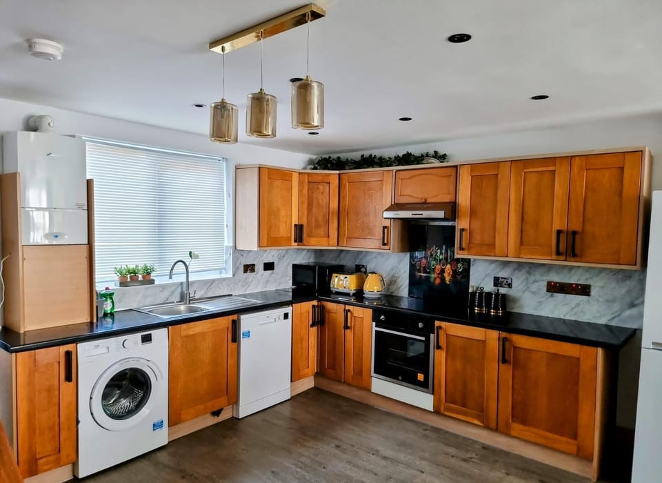 Kitchen or kitchenette, dishwasher, oven, stove, toaster, washing machine