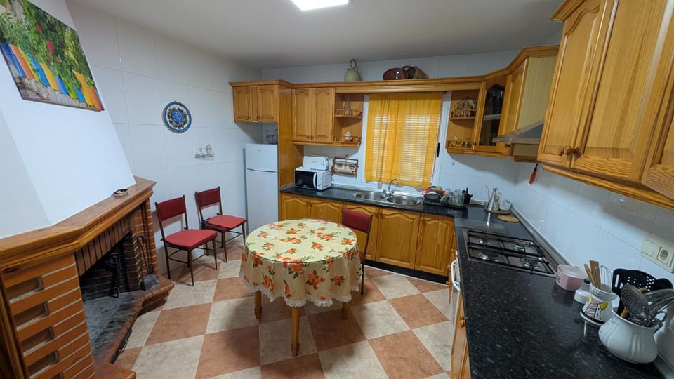 Kitchen or kitchenette, fireplace, microwave, oven, stove