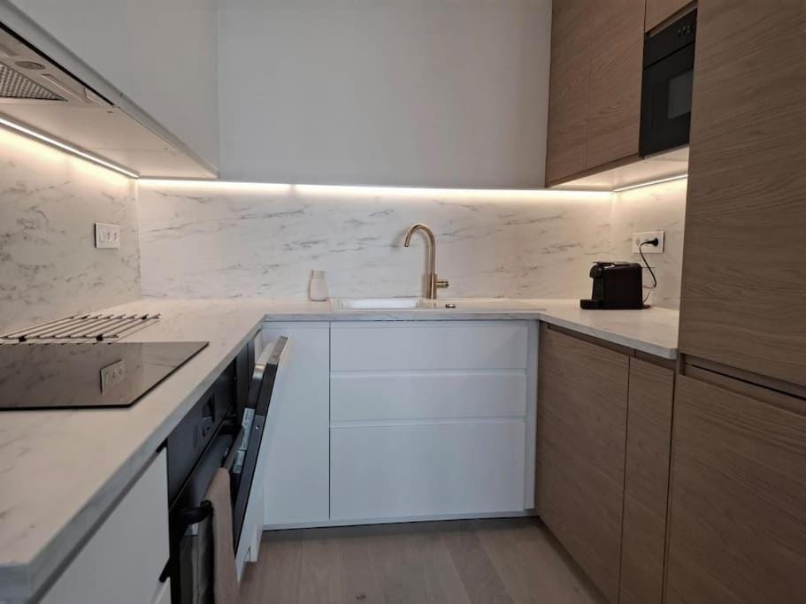 Kitchen or kitchenette, dishwasher, oven, stove