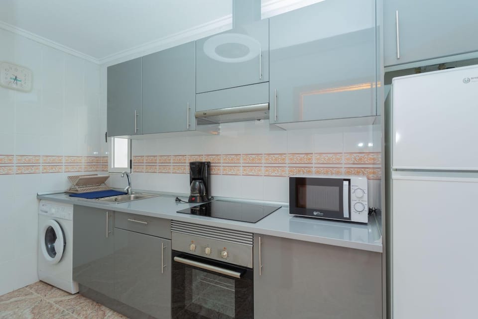Kitchen or kitchenette, oven, stove, toaster, washing machine