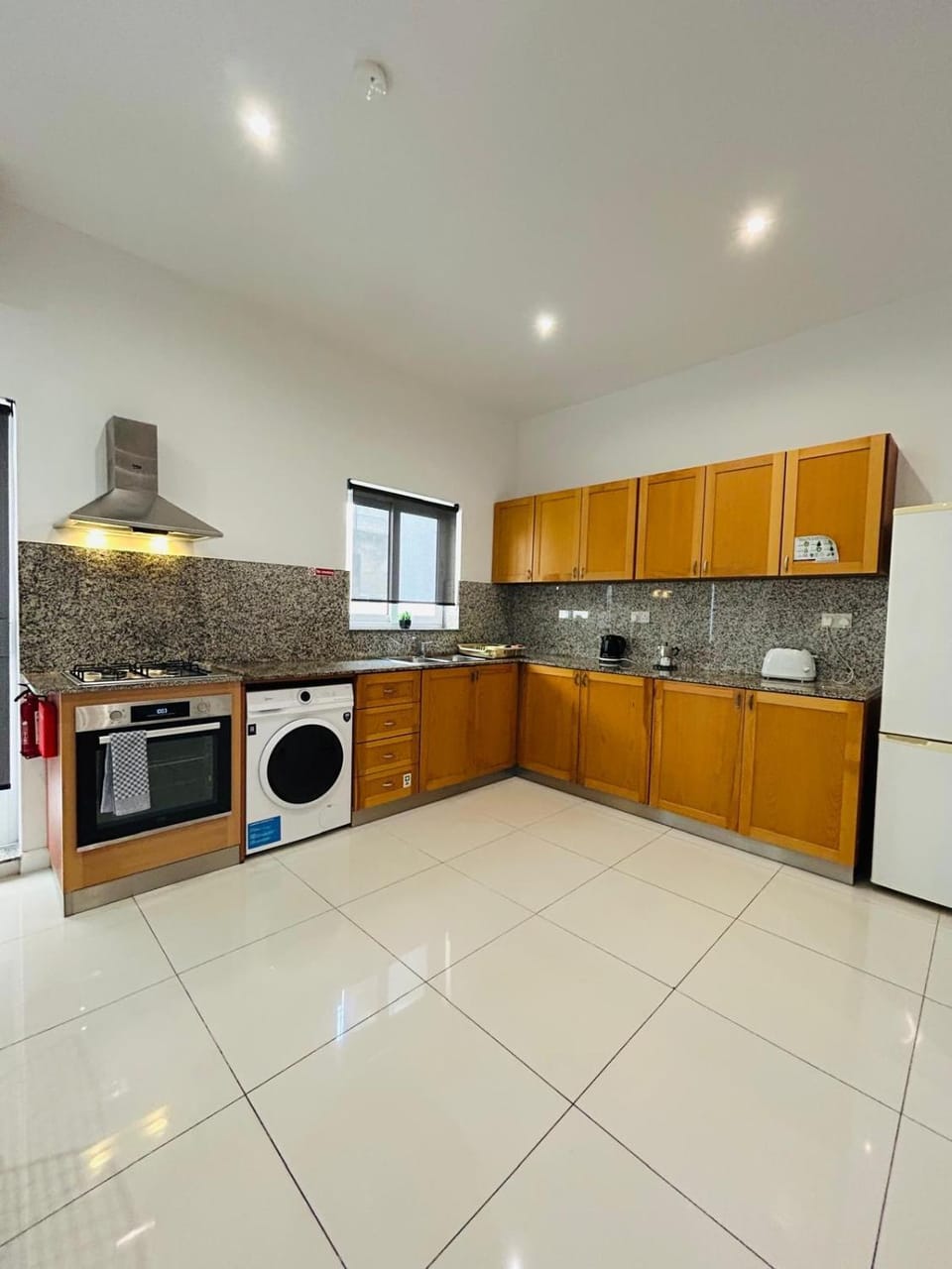 Kitchen or kitchenette, oven, stove, toaster, washing machine
