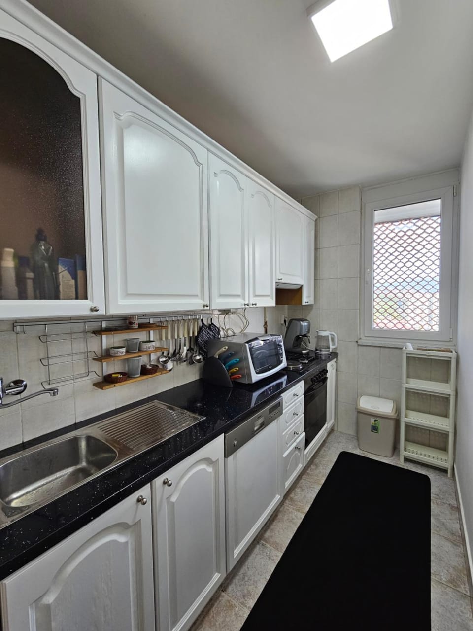 Kitchen or kitchenette, dishwasher, stove, toaster