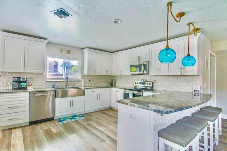 Kitchen or kitchenette, dishwasher, oven, stove