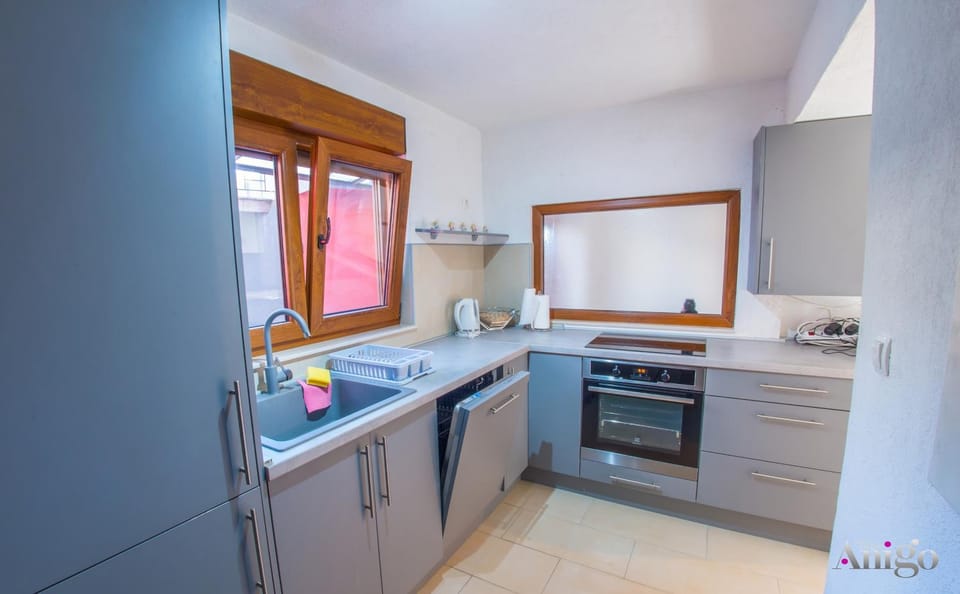 Kitchen or kitchenette, dishwasher, oven, stove