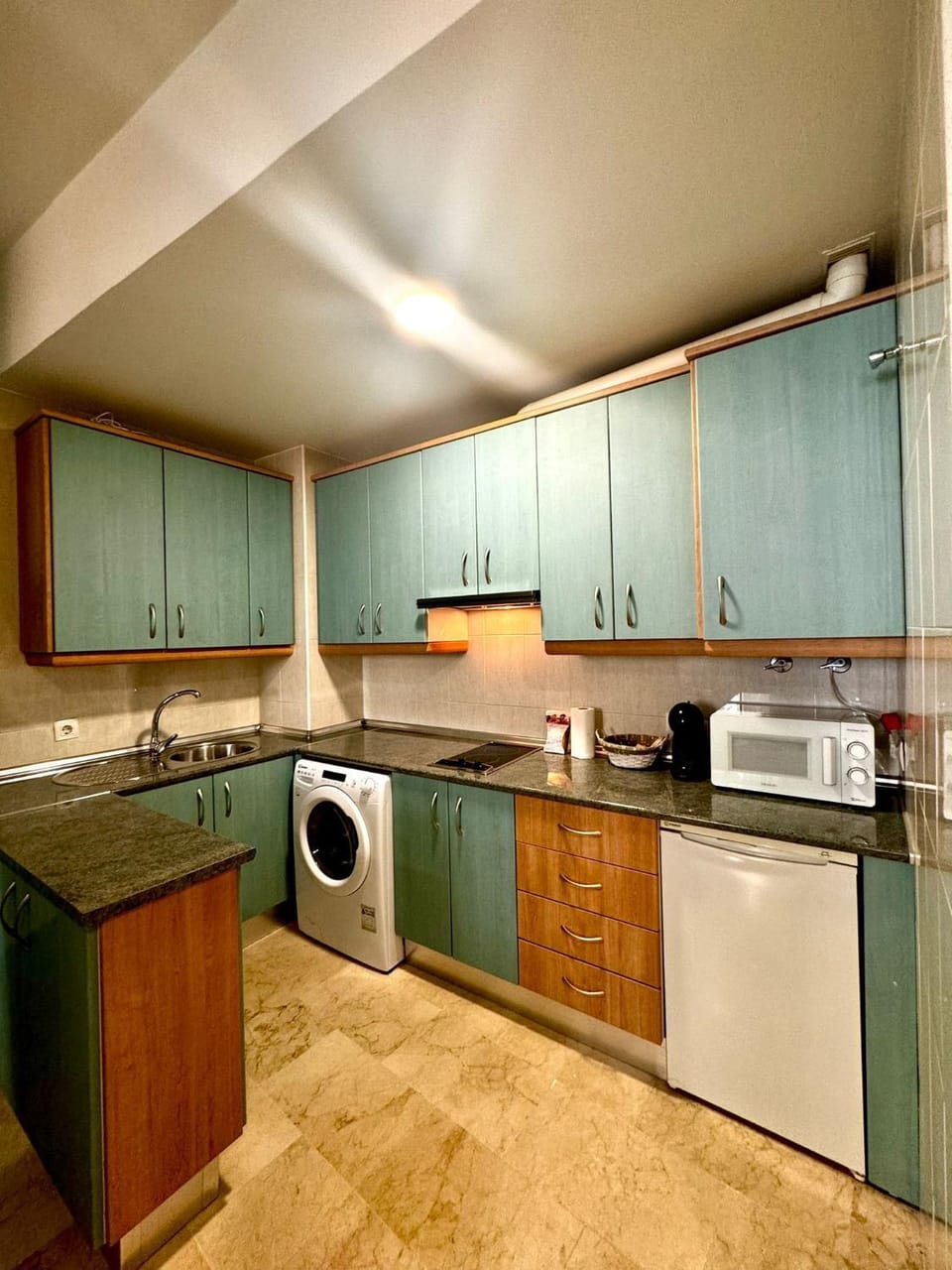 Kitchen or kitchenette, microwave, stove, washing machine