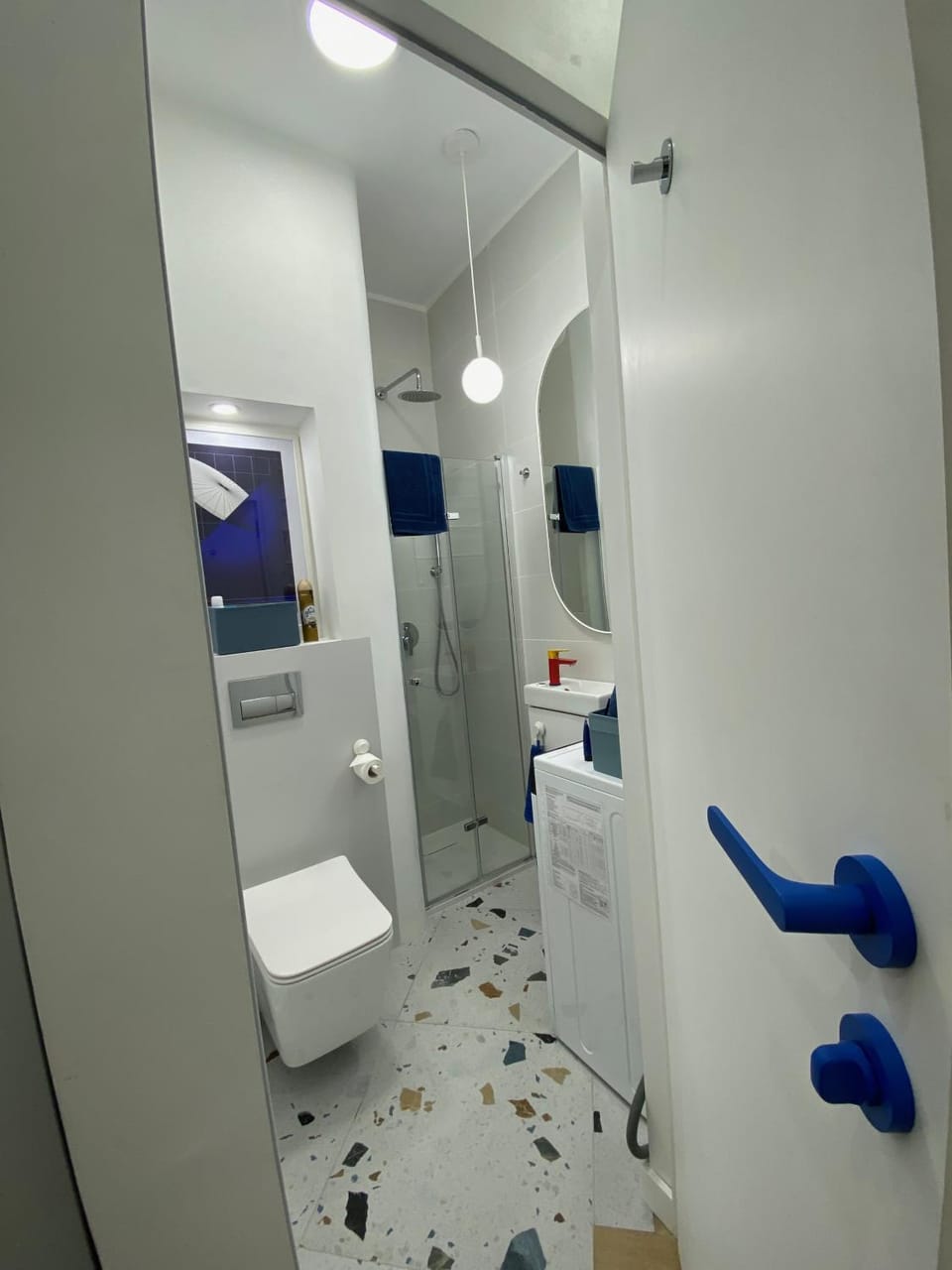 Shower, Toilet, Bathroom, hair dryier, towels, washing machine