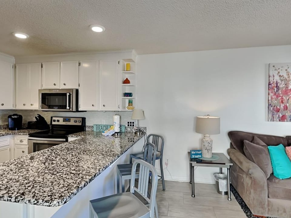 Kitchen or kitchenette, Living room, Seating area, furniture, microwave, oven, stove