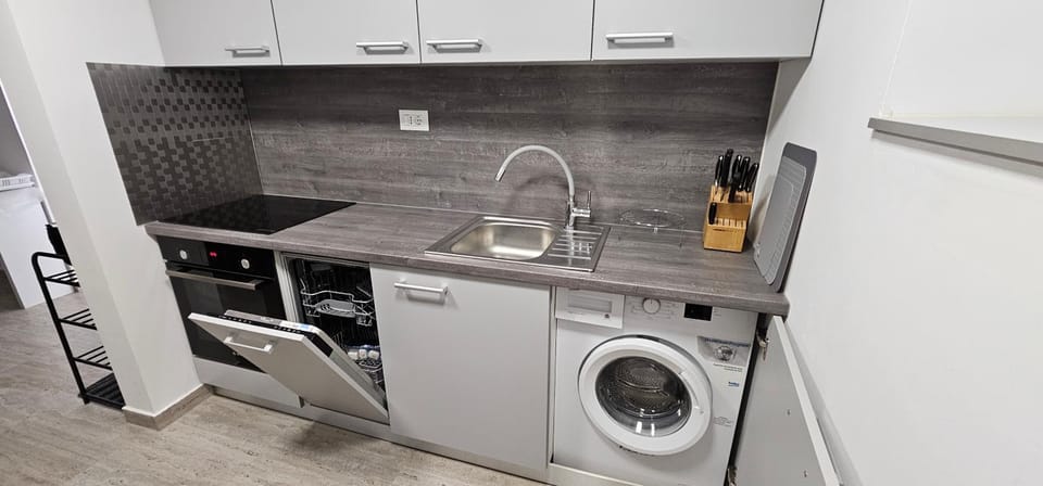 Kitchen or kitchenette, dishwasher, oven, stove, washing machine