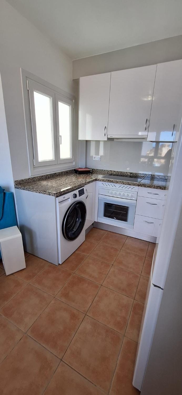 Kitchen or kitchenette, stove, washing machine