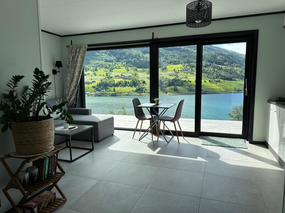 Natural landscape, View (from property/room), Balcony/Terrace, Living room, Seating area, Dining area, Lake view, Mountain view, River view