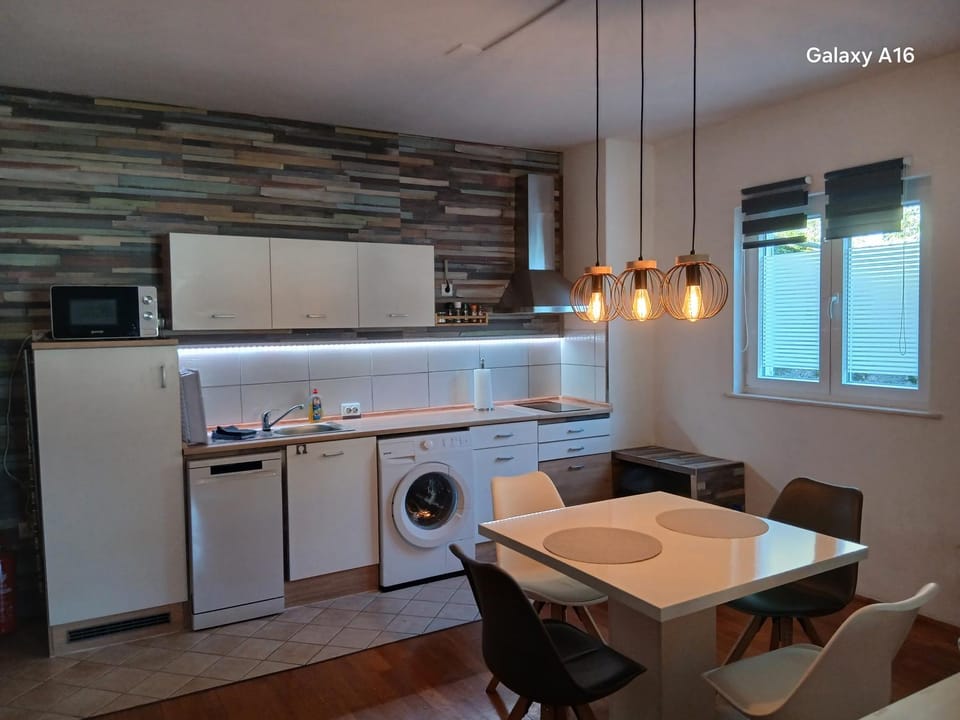 Kitchen or kitchenette, Dining area, dishwasher, microwave, stove, toaster, washing machine