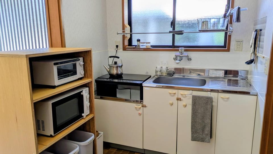 Kitchen or kitchenette, microwave, stove, toaster