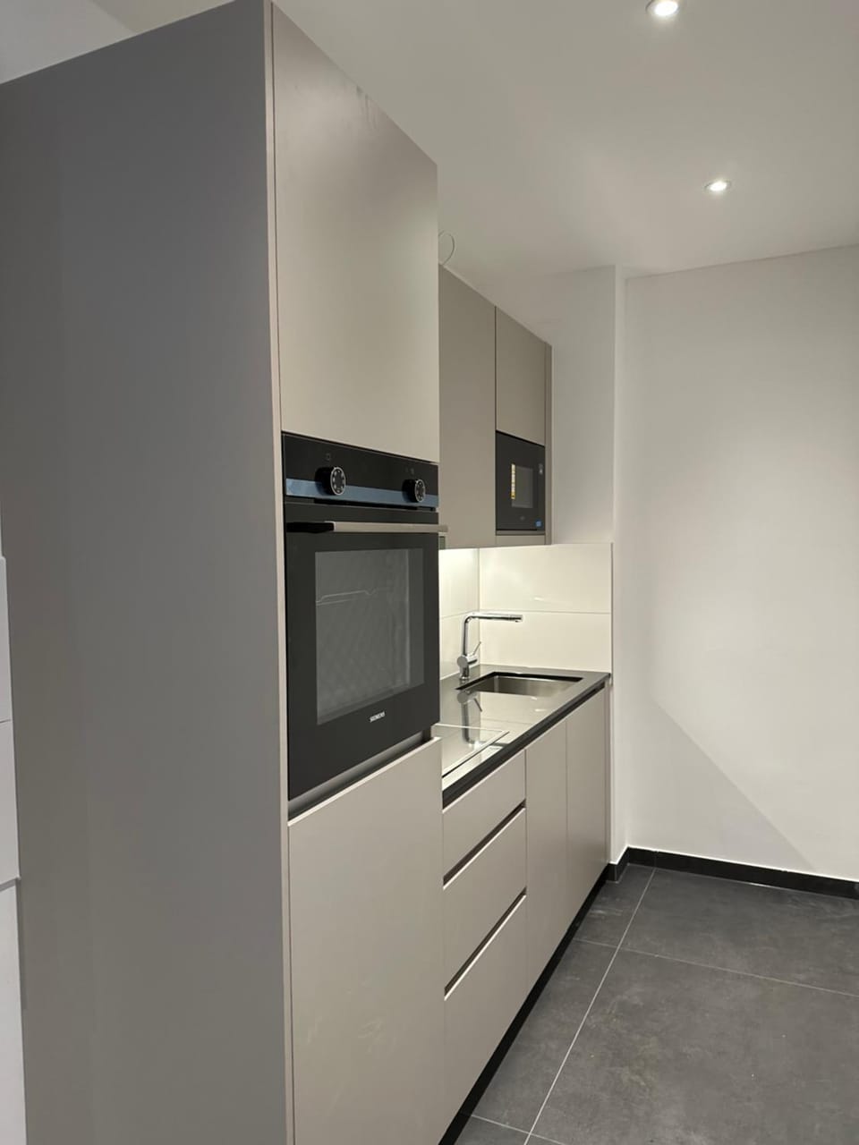Kitchen or kitchenette, dishwasher, oven, stove