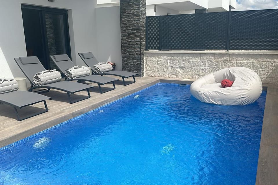 Patio, Day, Pool view, sunbed