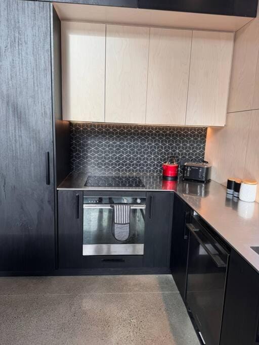 Kitchen or kitchenette, dishwasher, oven, stove