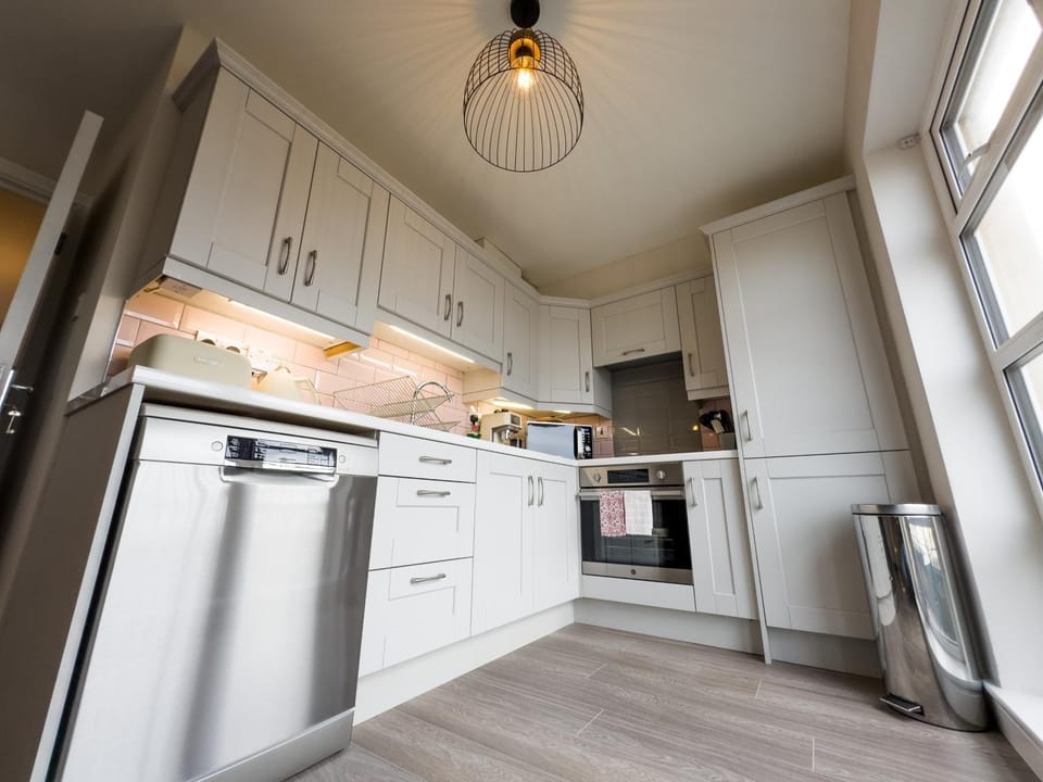Kitchen or kitchenette, dishwasher, oven, stove, toaster