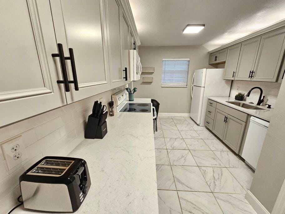 Kitchen or kitchenette, dishwasher, oven, stove, toaster