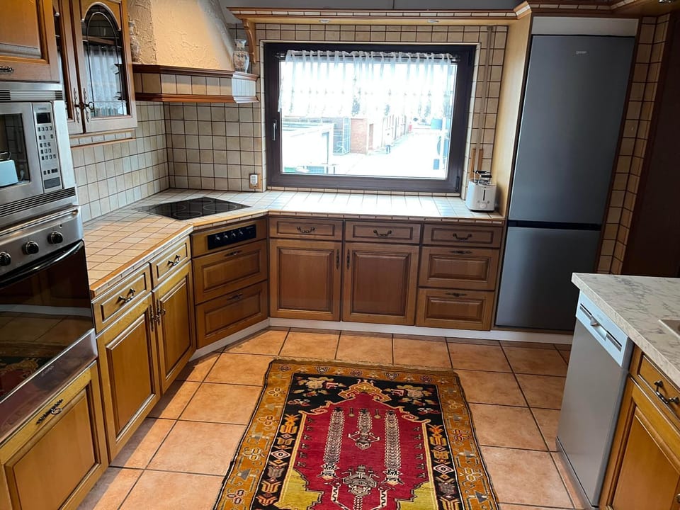 Kitchen or kitchenette, dishwasher, oven, stove