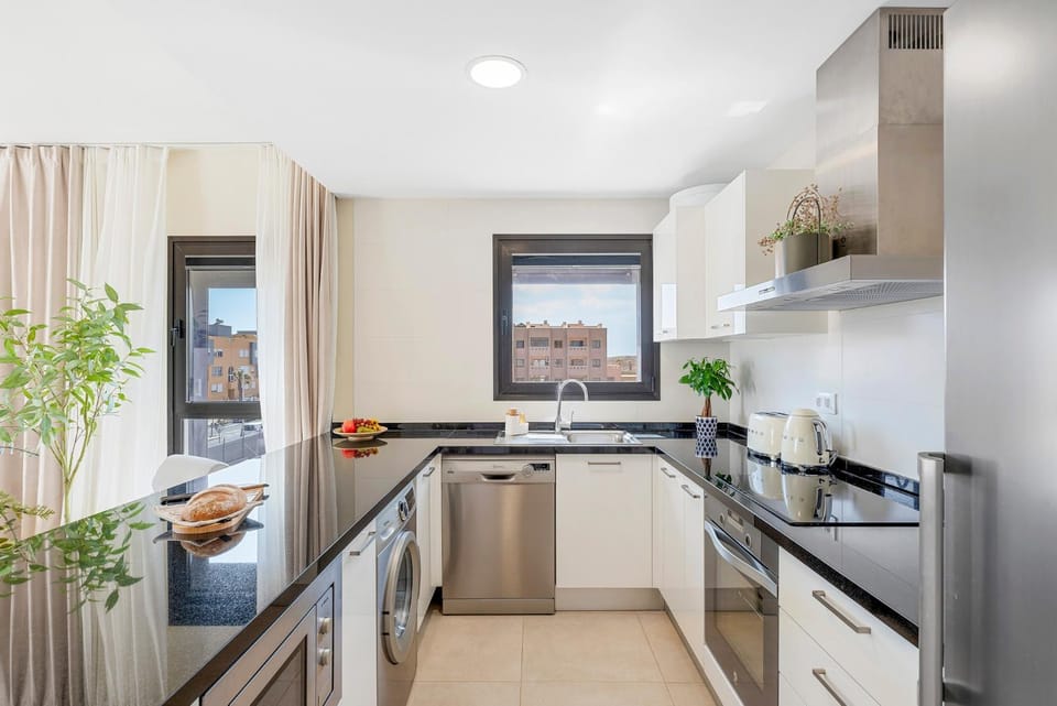 Kitchen or kitchenette, dishwasher, oven, stove, washing machine