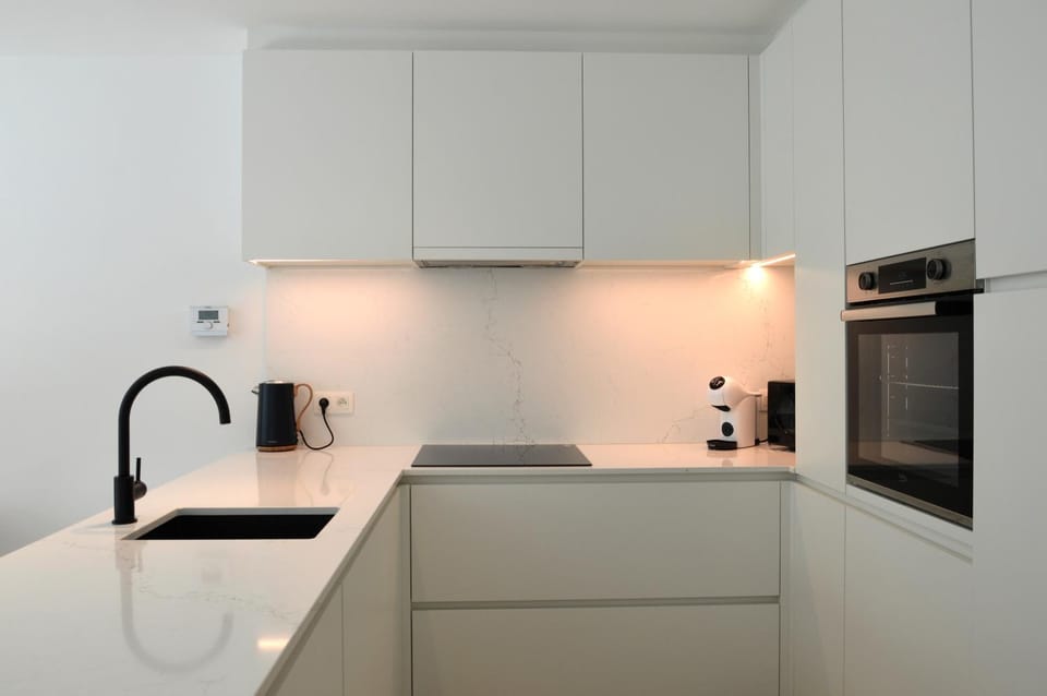 Kitchen or kitchenette, dishwasher, oven, stove