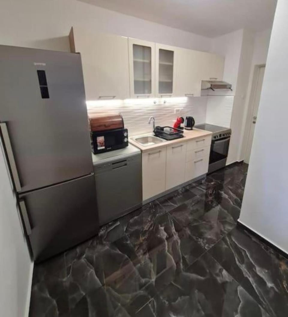 Kitchen or kitchenette, dishwasher, microwave, oven, stove