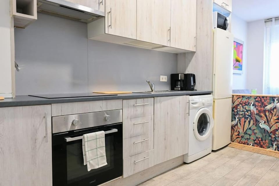 Kitchen or kitchenette, microwave, stove, washing machine