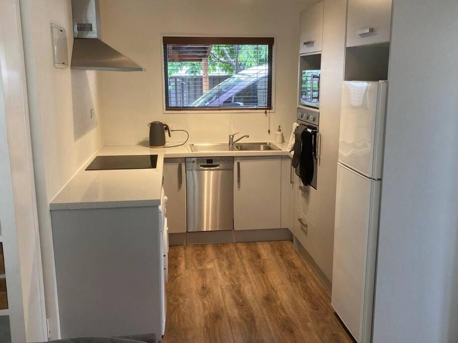 Kitchen or kitchenette, dishwasher, oven, stove