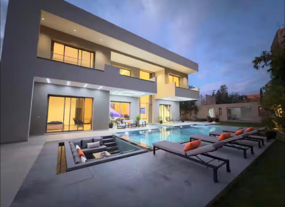 Property building, Patio, Day, Natural landscape, Living room, Seating area, Pool view, Swimming pool, sunbed