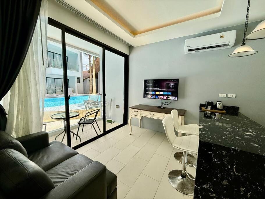 Living room, Seating area, Dining area, Pool view
